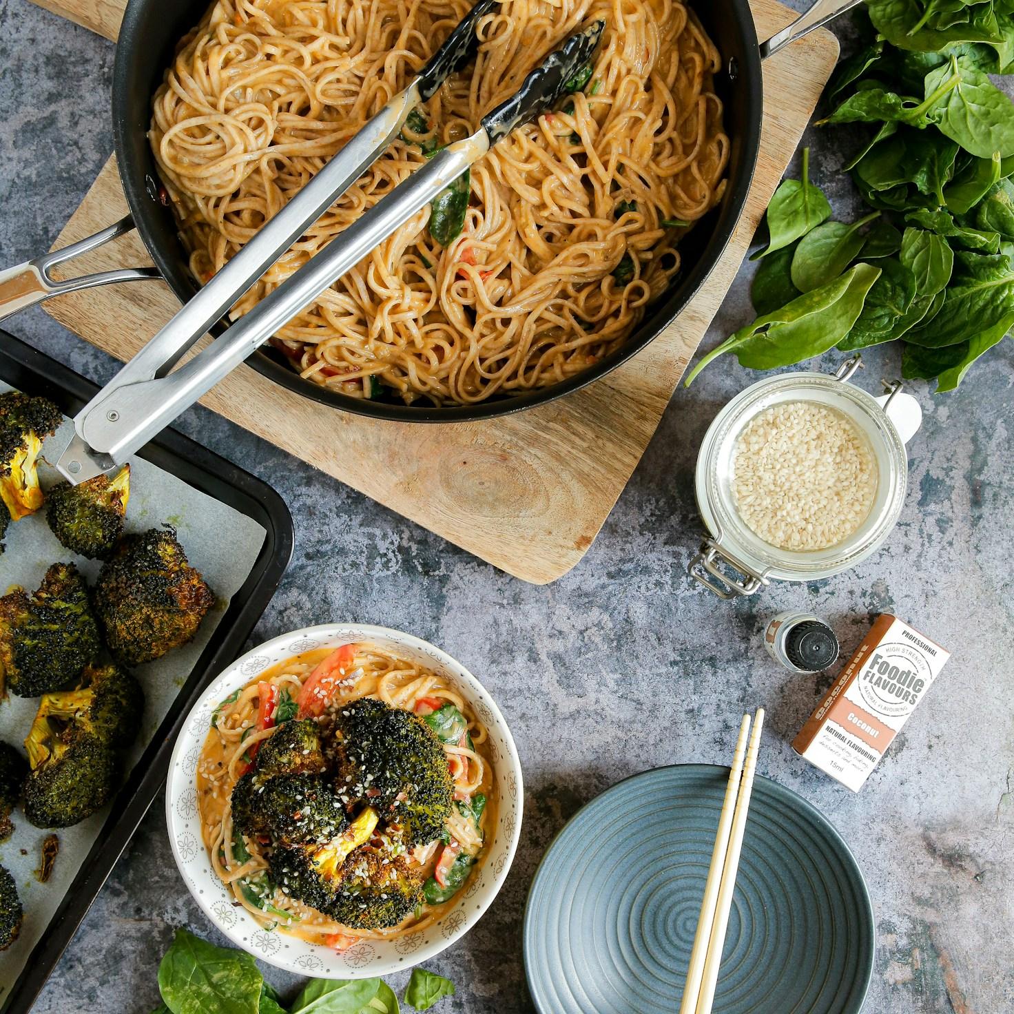 Community members cooking together in a contemporary kitchen, exchanging recipes and techniques